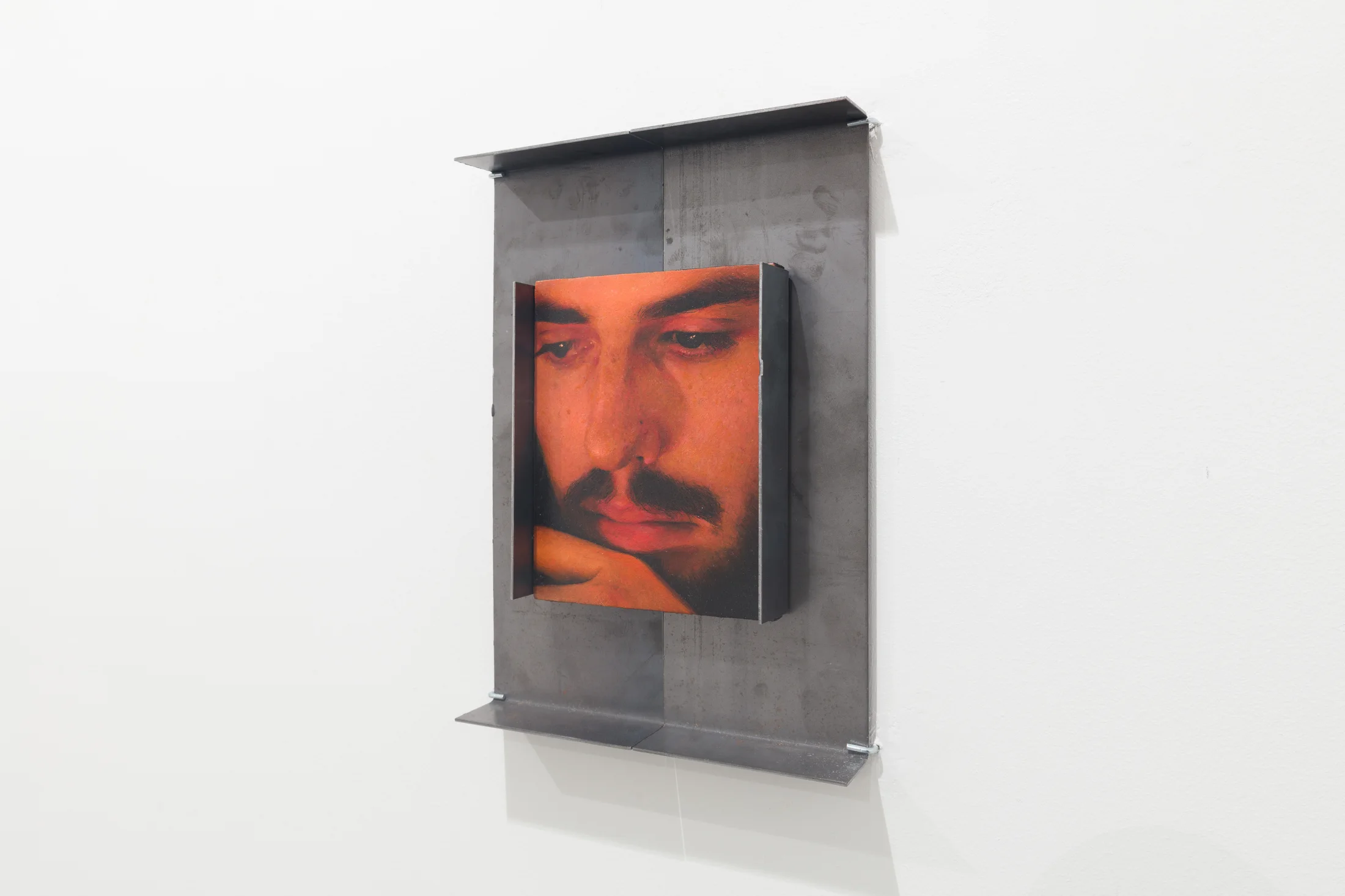 A painting by Ki Yoong of the closeup of a man's face in a metal frame