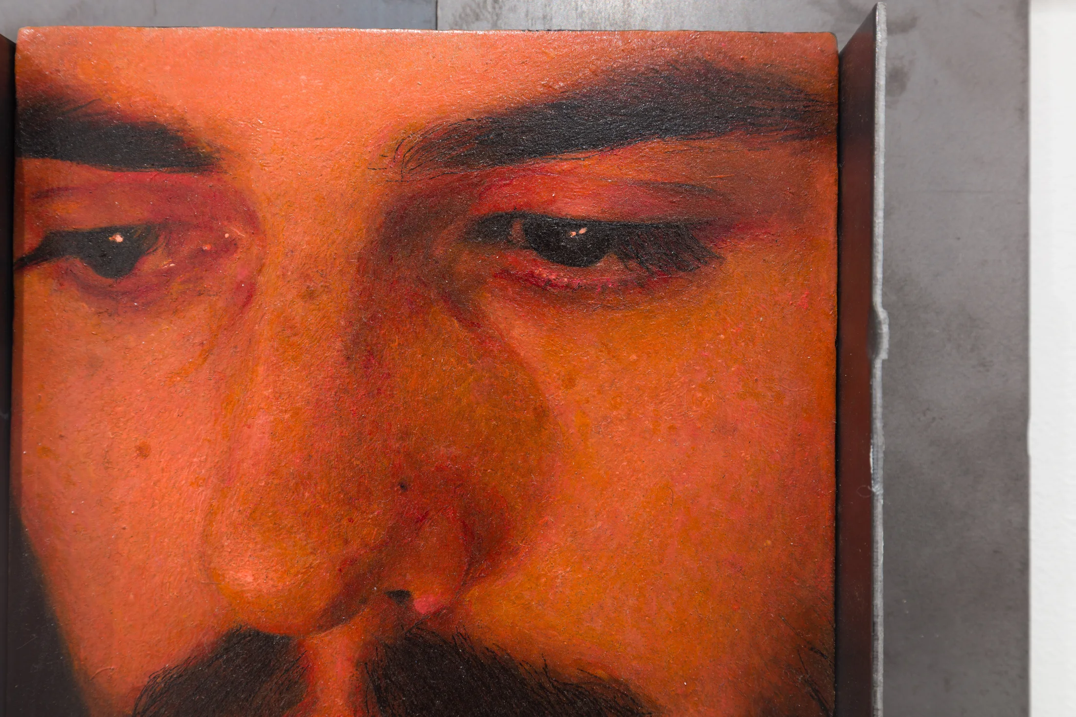 A painting by Ki Yoong of the closeup of a man's face in a metal frame