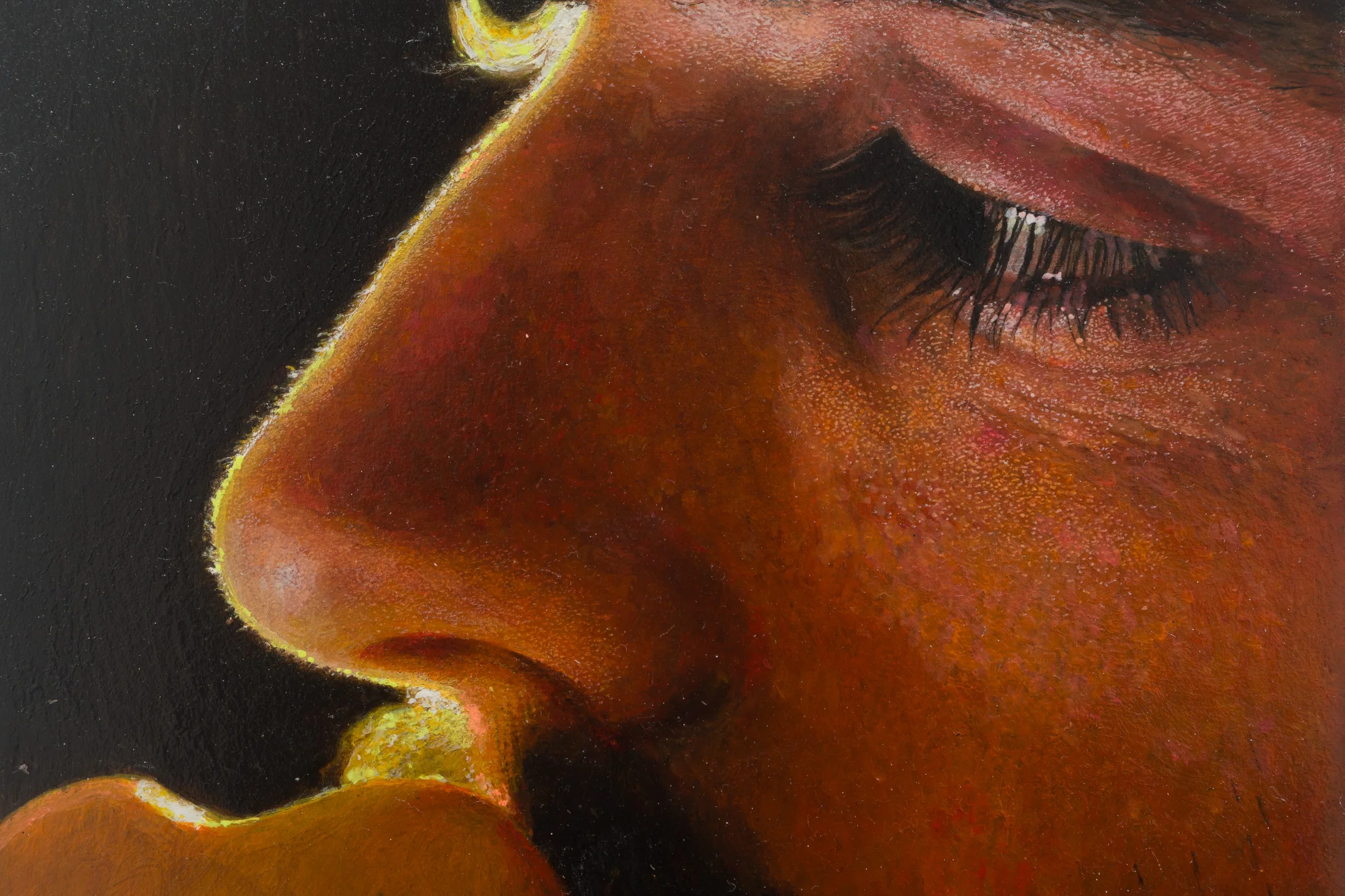 a painting by Ki Yoong of a close up of a male face against a dark background which hangs from a silver necklace