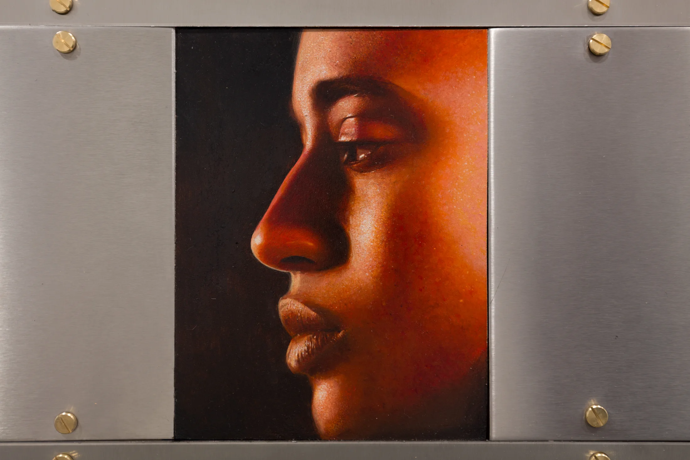 A painting by Ki Yoong of the side profile of a young man's face in a steel frame