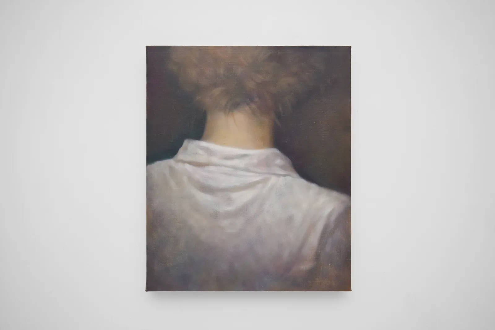 Short haired person from behind wearing white cotton shirt 