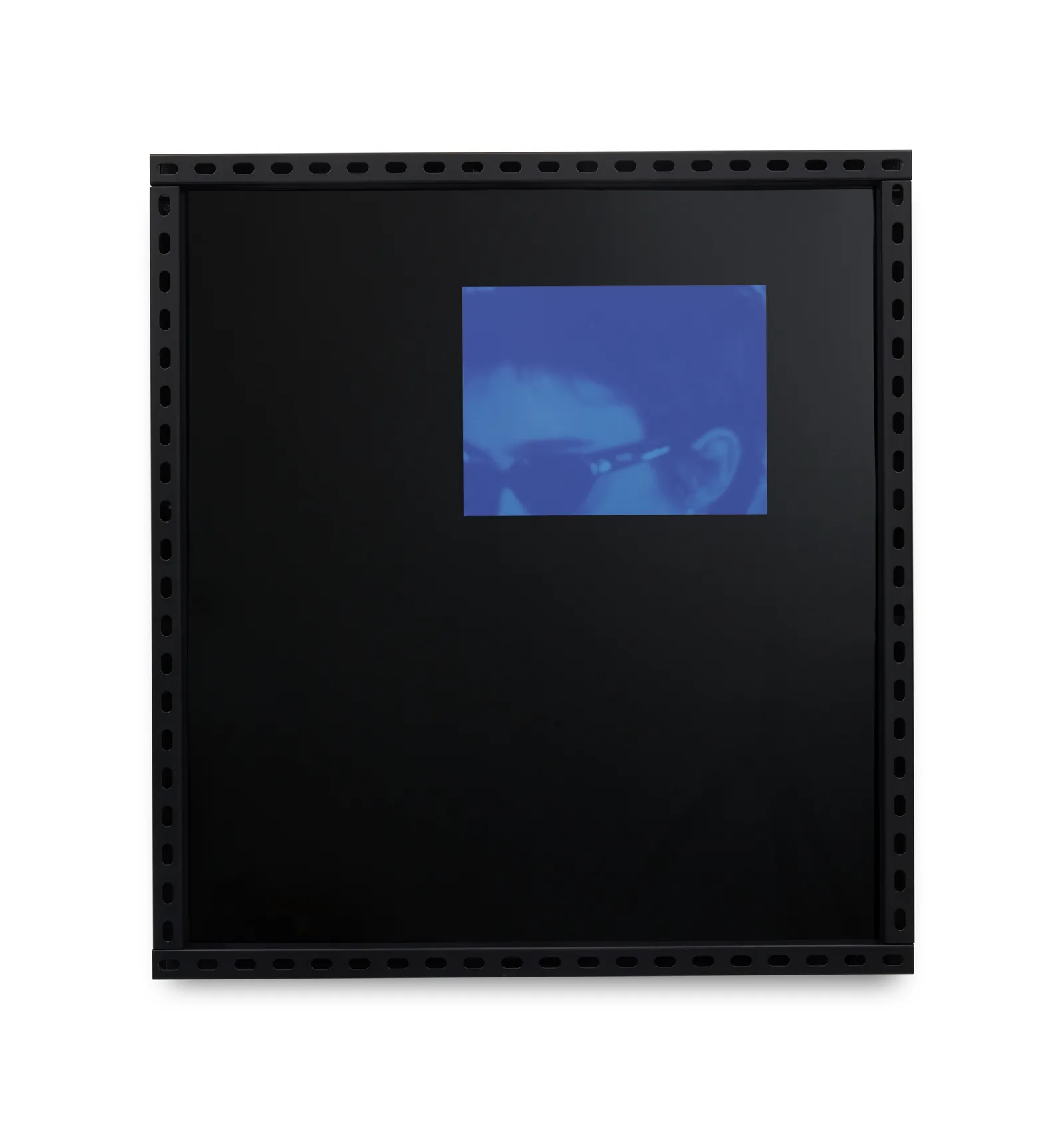Black acrylic artwork featuring a cropped image of a man wearing sunglasses in a blue hue. 