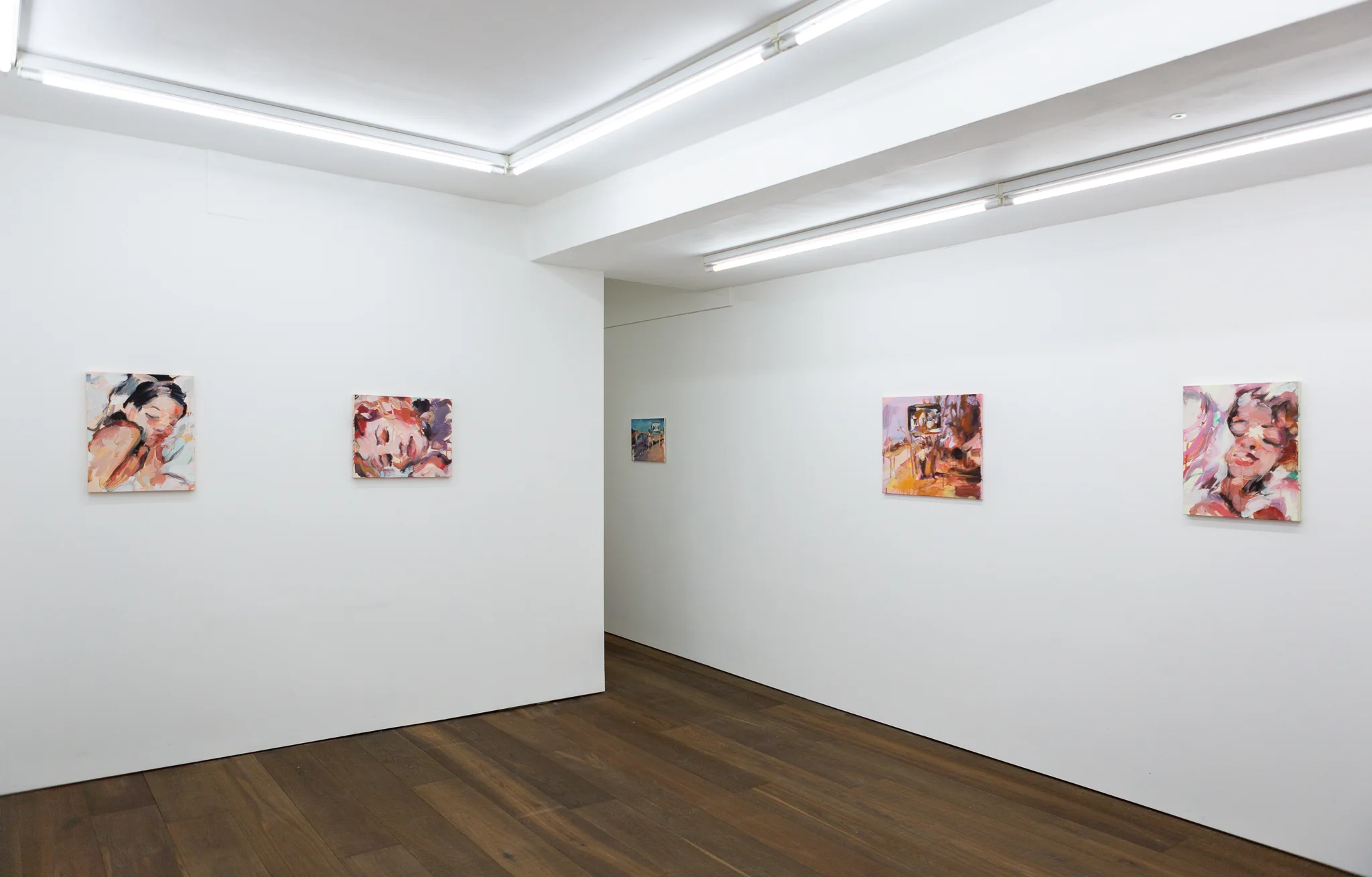 Installation shots of Laura Lancaster's solo show at Workplace London. Close up crop paintings of sleeping women and figures in landscapes, loosely painted.