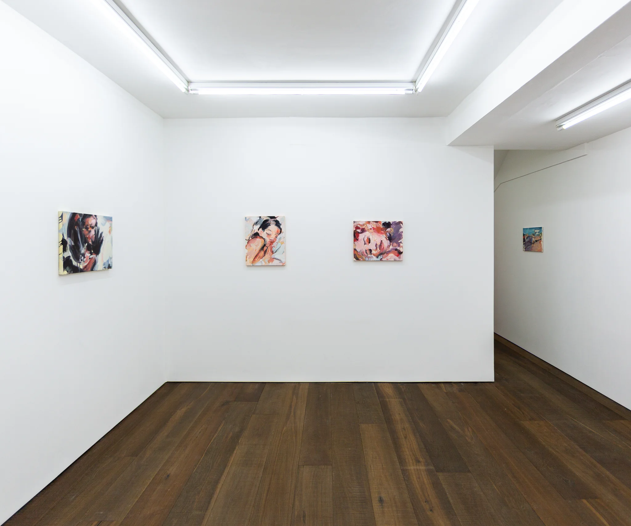Installation shots of Laura Lancaster's solo show at Workplace London. Close up crop paintings of sleeping women and figures in landscapes, loosely painted.