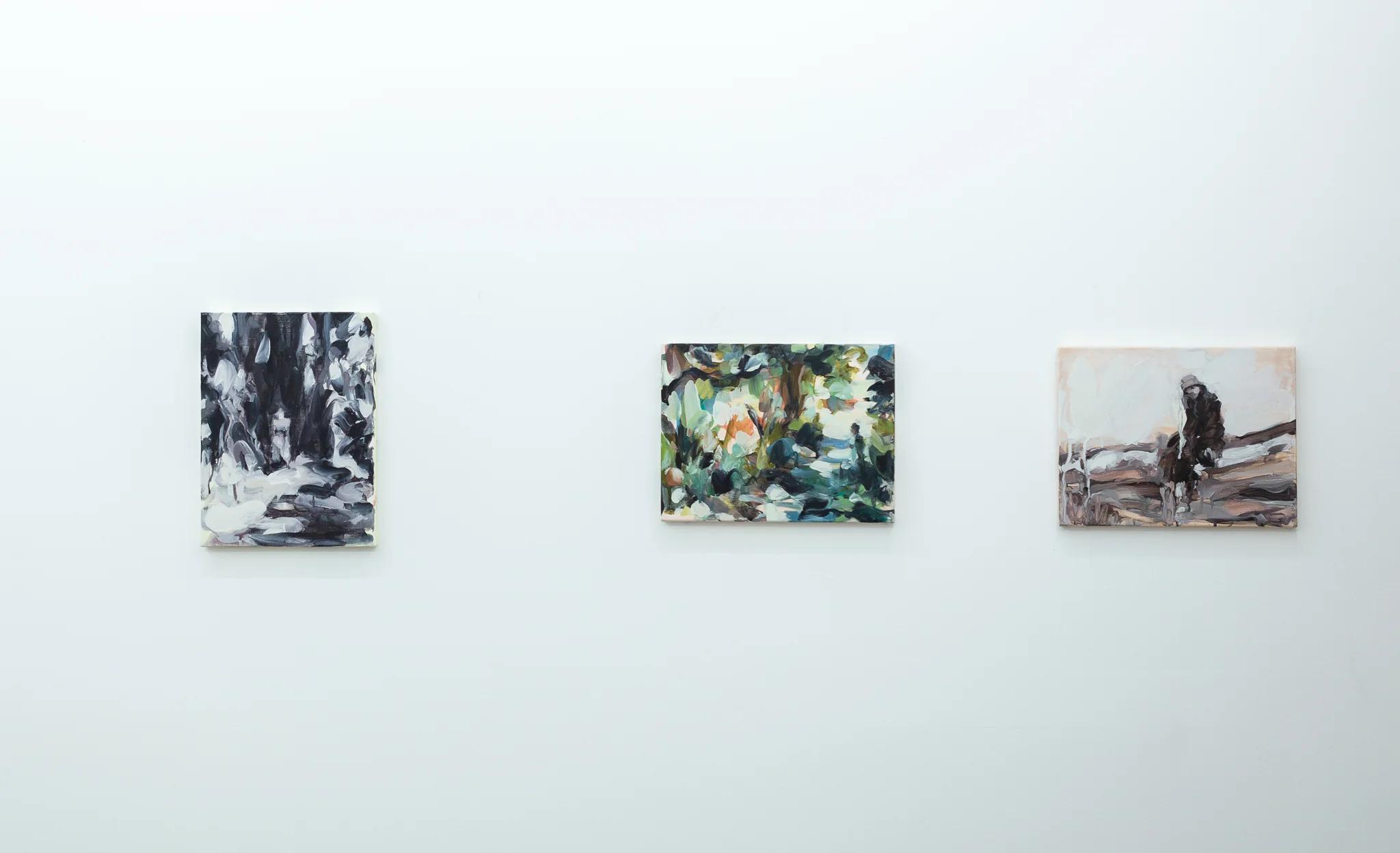 Installation shots of Laura Lancaster's solo show at Workplace London. Close up crop paintings of sleeping women and figures in landscapes, loosely painted.