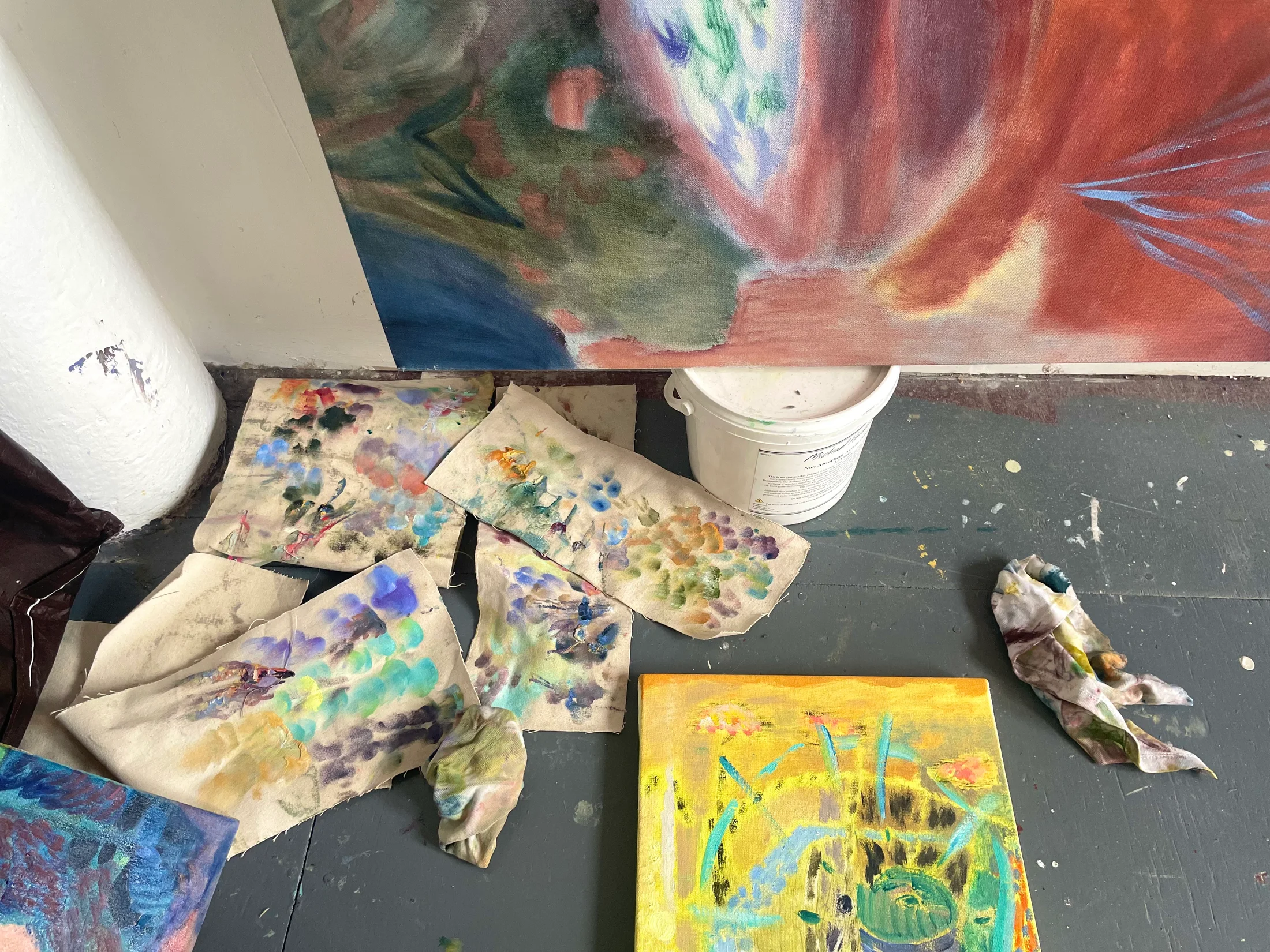 A table with paint and sketchbooks in Amy Winstanley's studio