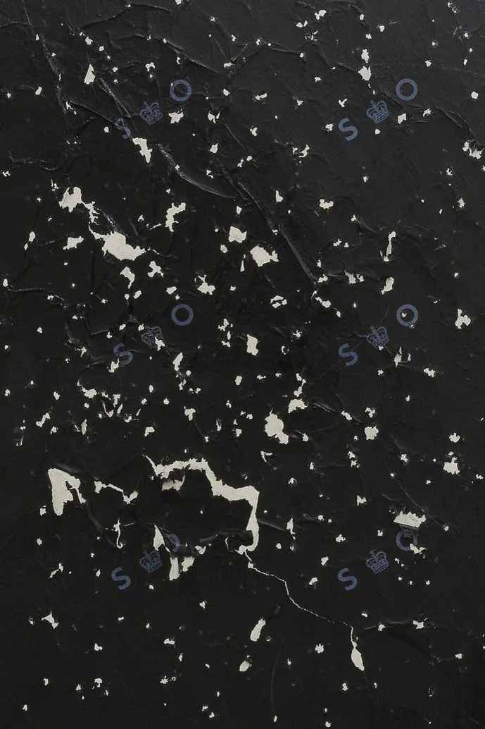 A crop of a painting by Jennifer Douglas made with carbon copy paper on grey floor paint. An insignia from the post office Sorting Office reads 'S-O'