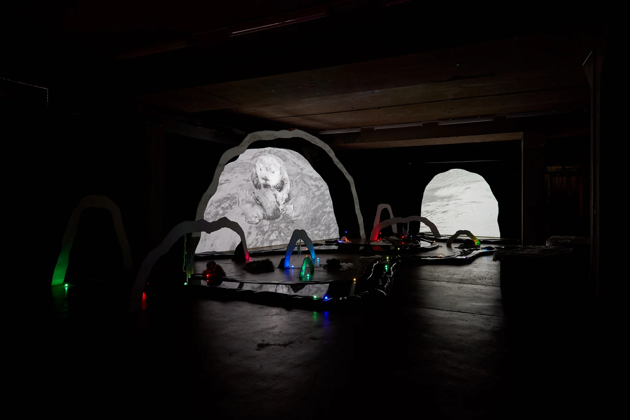 An installation by Hazel Brill of a number of amorphous forms with abstracted imagery projected onto them 
