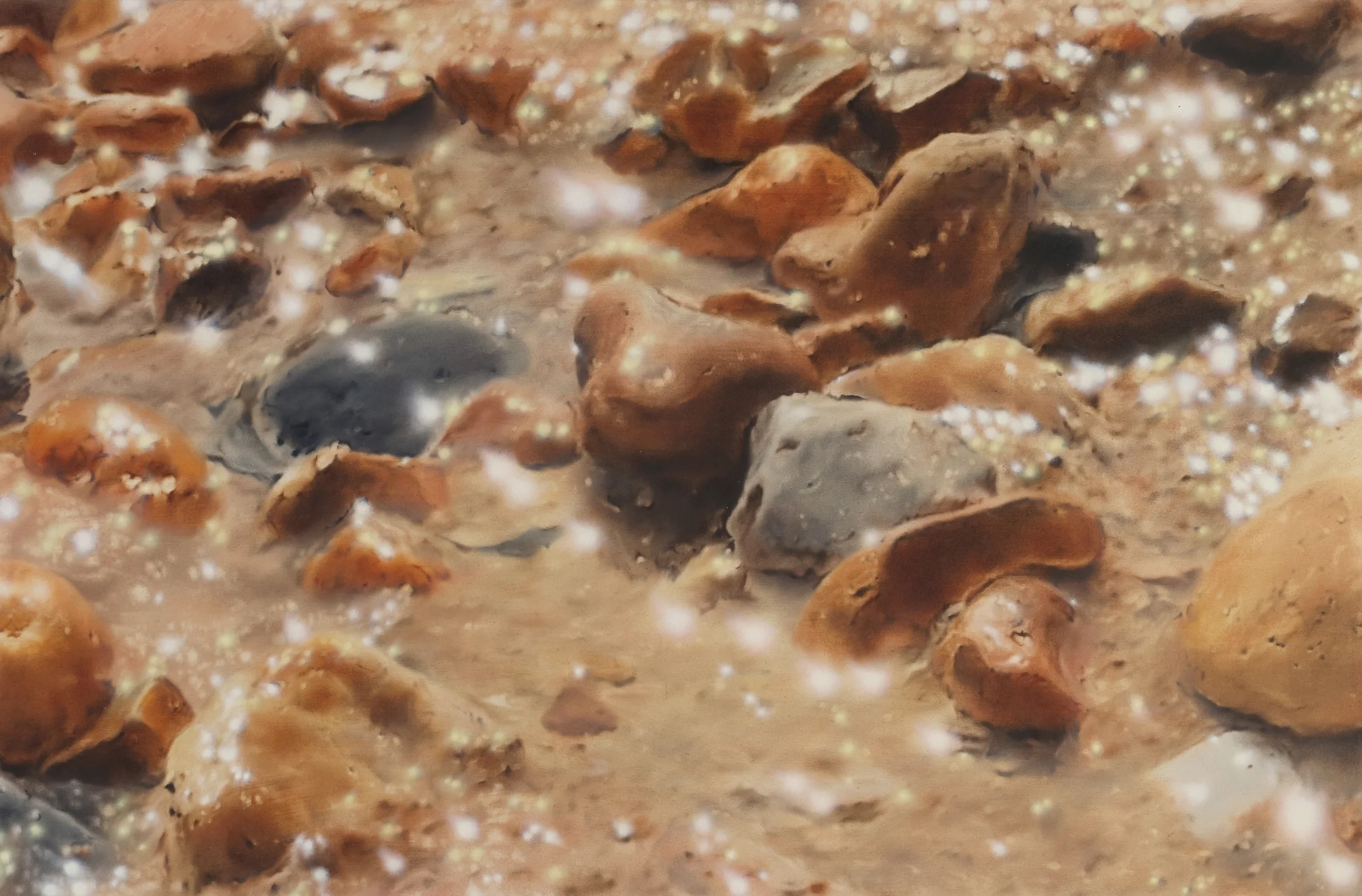 A detail of a painting by James Prapaithong of rocks on samd with bright sunshine reflecting off the water