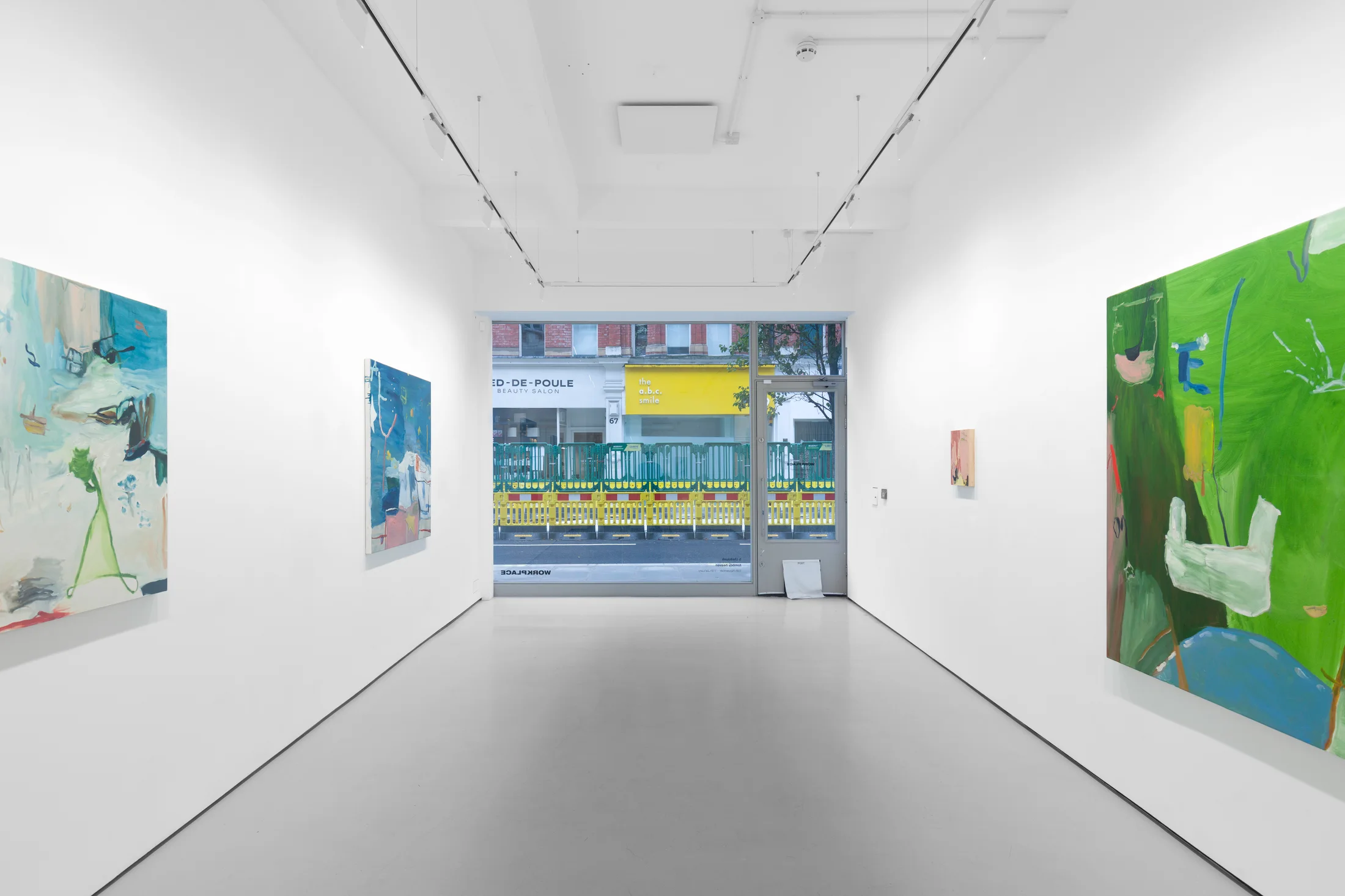 A white walled gallery with 4 artworks by b chehayeb hung on the walls