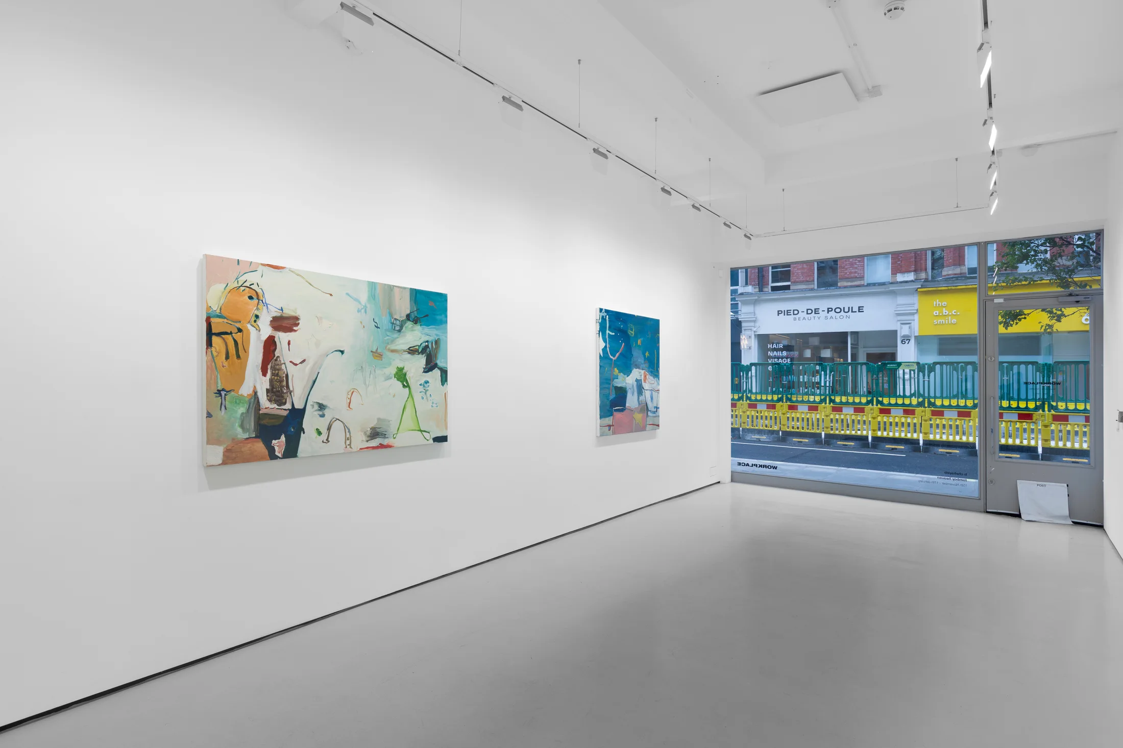 A white walled gallery with 4 artworks by b chehayeb hung on the walls