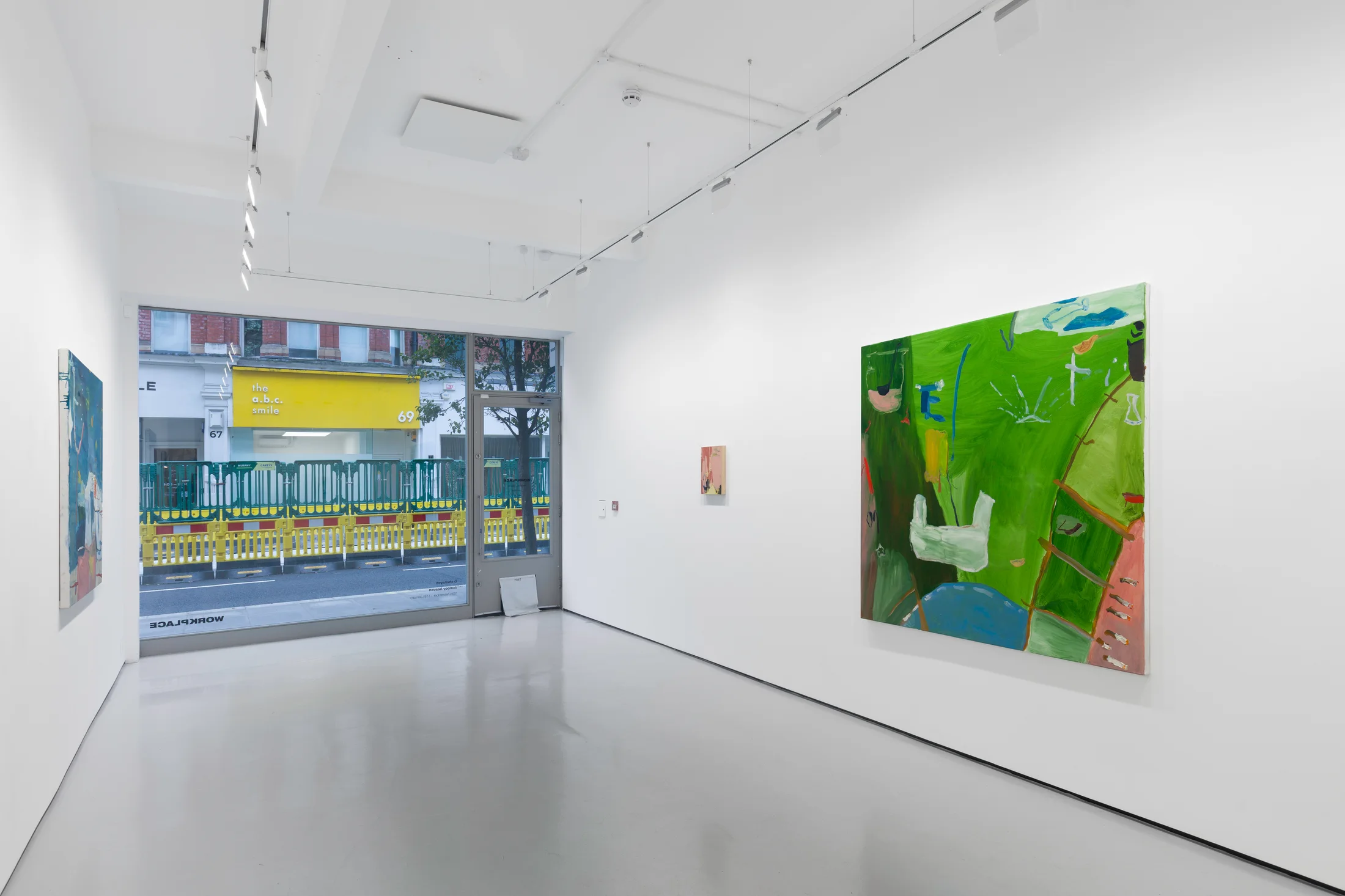 A white walled gallery with 4 artworks by b chehayeb hung on the walls
