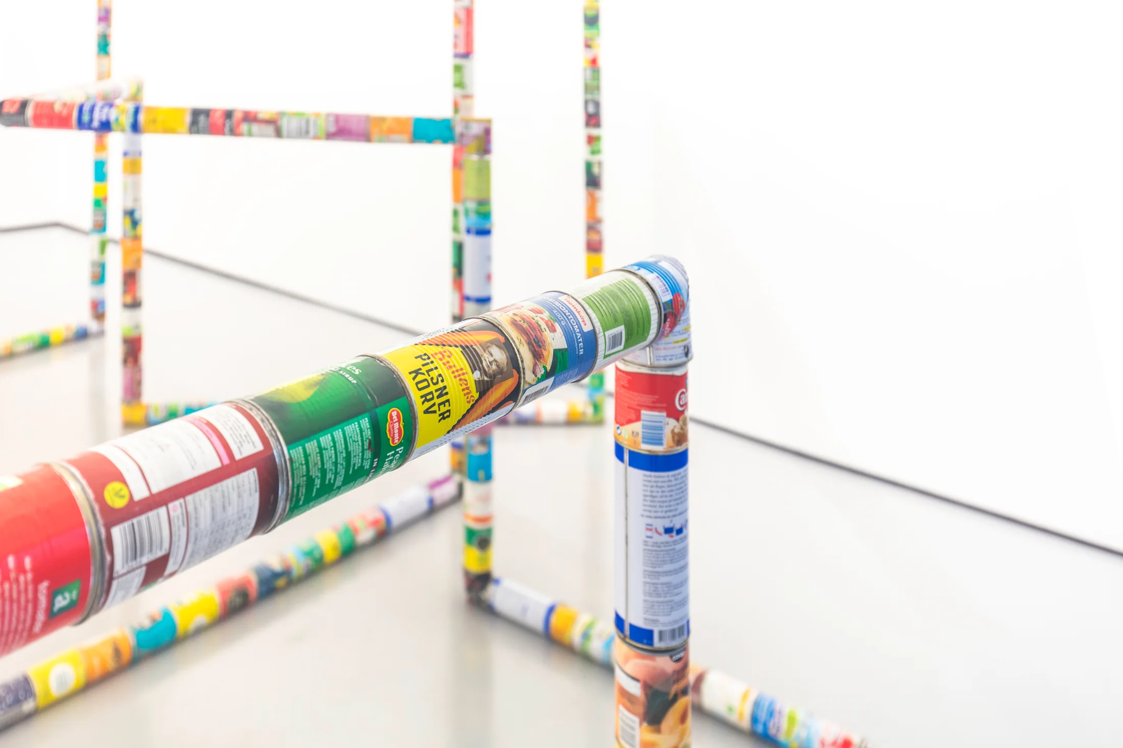 A sculpture by Jacob Dahlgren of various types of food cans connected end to end to create an endless loop