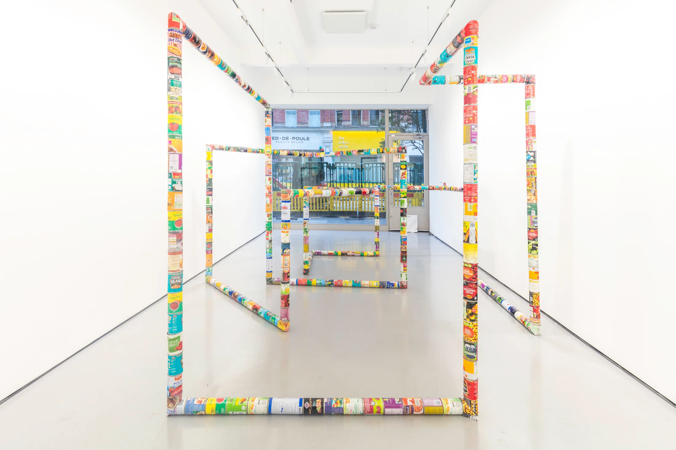 A sculpture by Jacob Dahlgren of various types of food cans connected end to end to create an endless loop